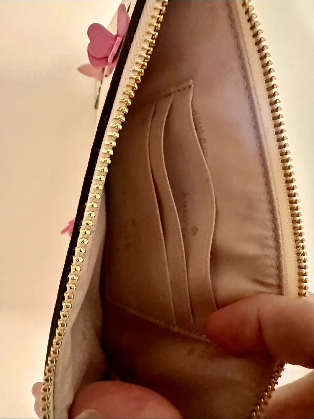 Kate Spade white wristlet with lilac floral appliqués and green leaves
